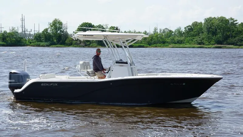 Slide: The Image of 2021 Sea Fox 248 Commander boat cruising on a river with lush green shoreline. - 4
