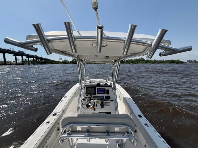 Slide: The Image of 2021 Sea Fox 248 Commander boat on water, featuring a sleek console and rod holders. - 5