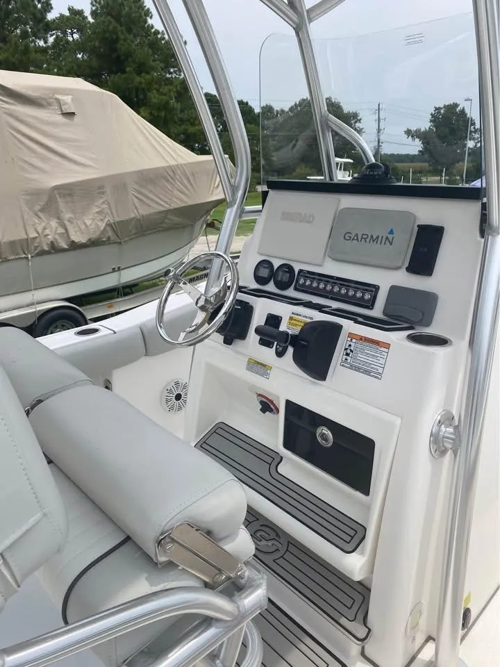 Slide: The Image of 2021 Sea Fox 248 Commander boat cockpit with Garmin navigation system and sleek white interior. - 7