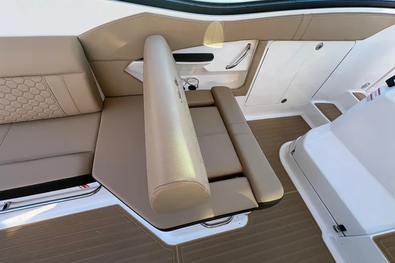 Slide: The Image of 2026 Sea Ray Sundancer 320 Outboard interior with beige seating and modern design. - 12