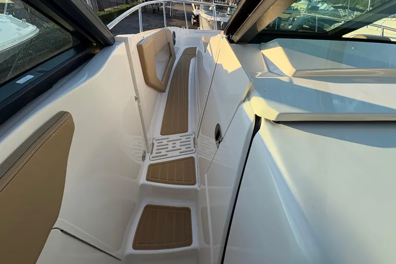 Slide: The Image of 2026 Sea Ray Sundancer 320 Outboard deck with tan seating and white finish. - 13