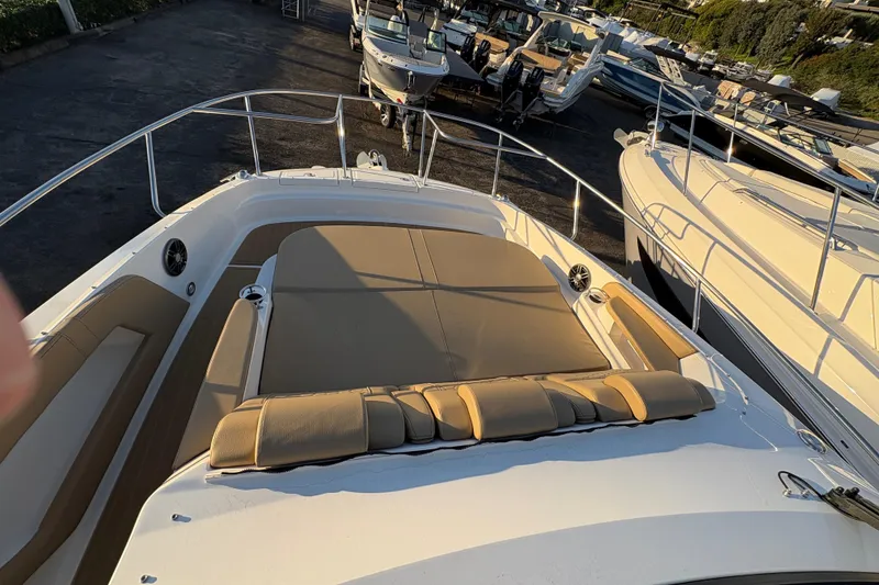 Slide: The Image of 2026 Sea Ray Sundancer 320 Outboard with spacious deck and comfortable seating in marina. - 14