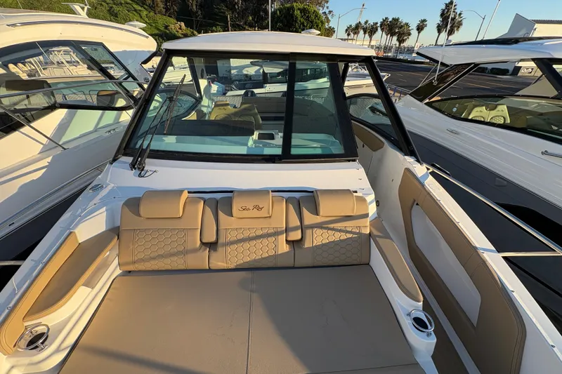 Slide: The Image of 2026 Sea Ray Sundancer 320 Outboard boat interior with tan seating and modern design. - 16
