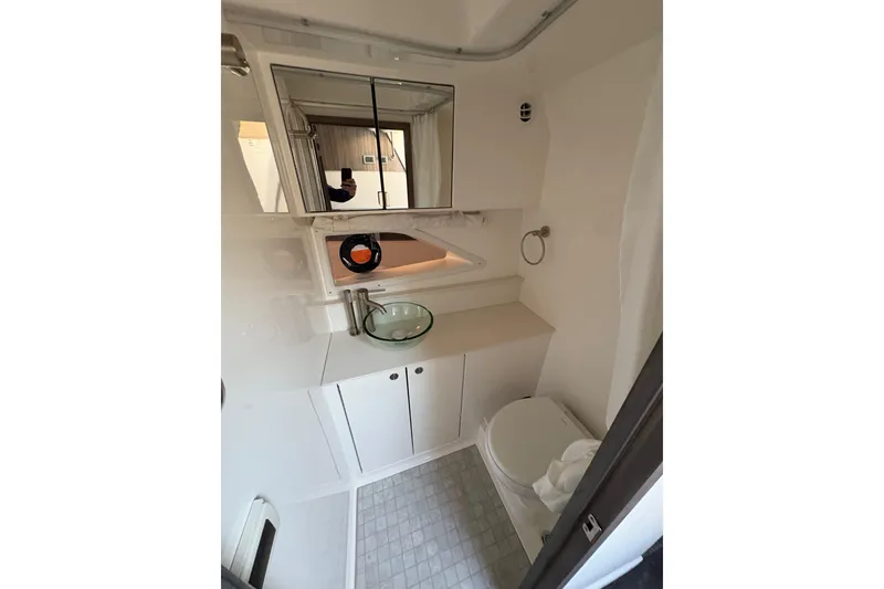 Slide: The Image of 2026 Sea Ray Sundancer 320 Outboard bathroom with modern fixtures and compact design. - 22