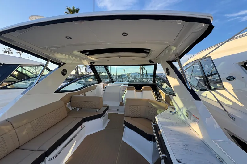 Slide: The Image of 2026 Sea Ray Sundancer 320 Outboard interior with luxurious seating and modern design. - 7