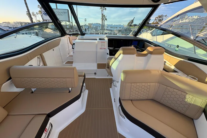 Slide: The Image of 2026 Sea Ray Sundancer 320 Outboard interior with luxurious seating and modern design. - 9