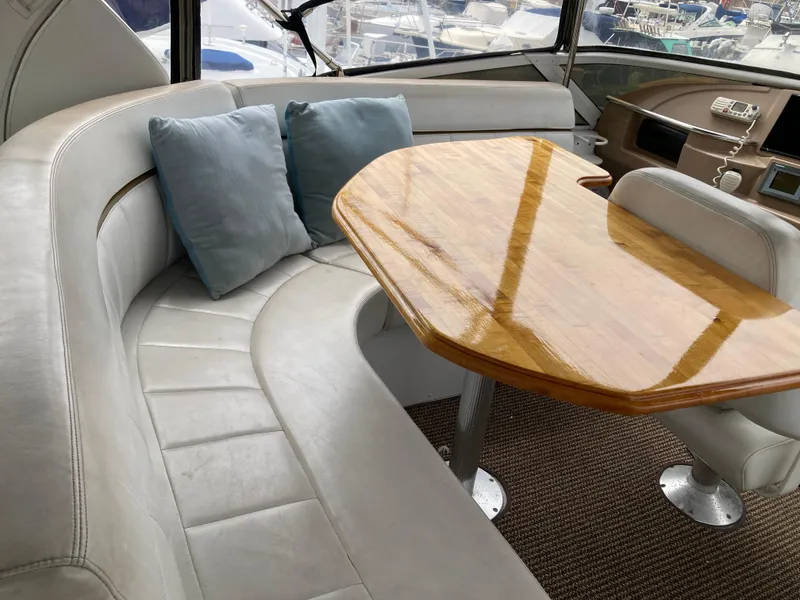 Slide: The Image of Interior of 2001 Carver 396 Aft Cabin with plush seating and wooden table. - 16