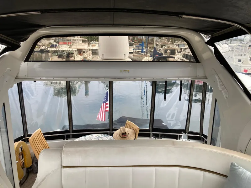 Slide: The Image of Interior view of 2001 Carver 396 Aft Cabin yacht with marina backdrop. - 20