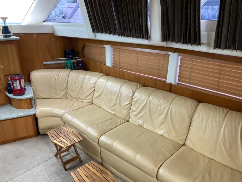 Slide: The Image of Luxurious interior of 2001 Carver 396 Aft Cabin yacht with beige leather seating. - 23