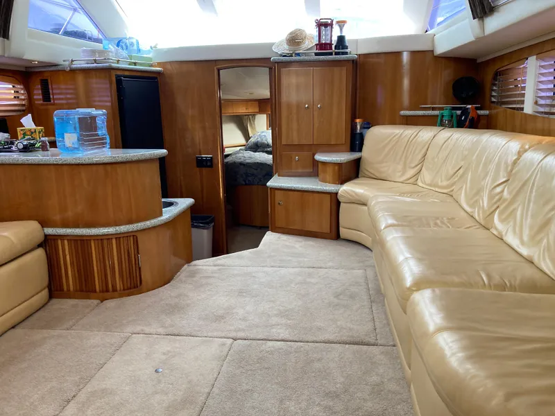 Slide: The Image of Interior of 2001 Carver 396 Aft Cabin yacht with leather seating and wood finishes. - 25