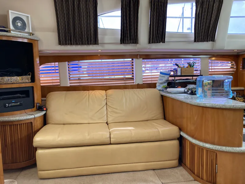 Slide: The Image of Interior of 2001 Carver 396 Aft Cabin with beige sofa and wooden cabinetry. - 27