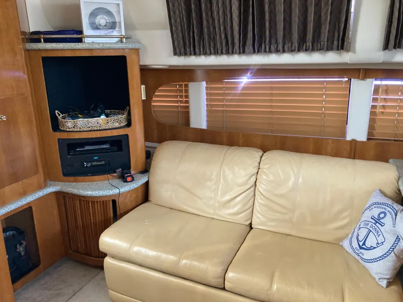 Slide: The Image of Interior of 2001 Carver 396 Aft Cabin with beige leather sofa and entertainment center. - 28