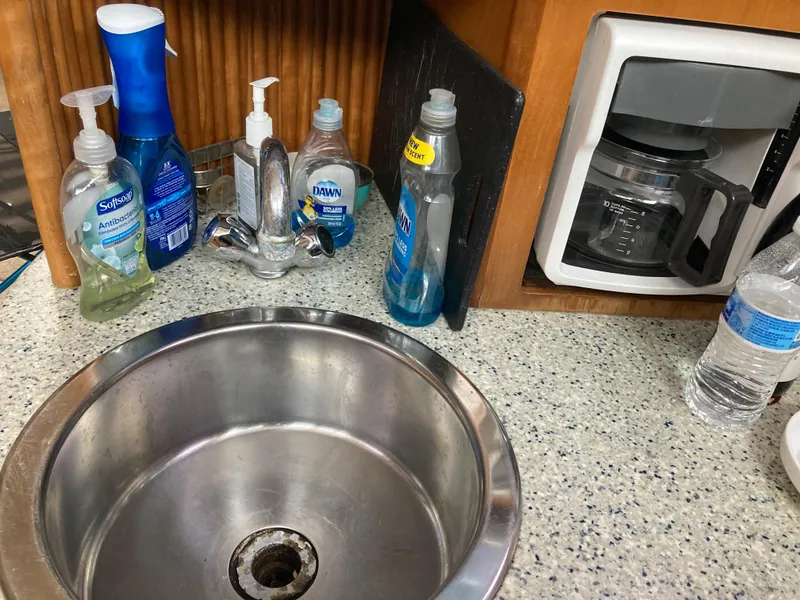 Slide: The Image of Kitchen sink area with cleaning supplies and coffee maker on Carver 396 Aft Cabin yacht. - 32