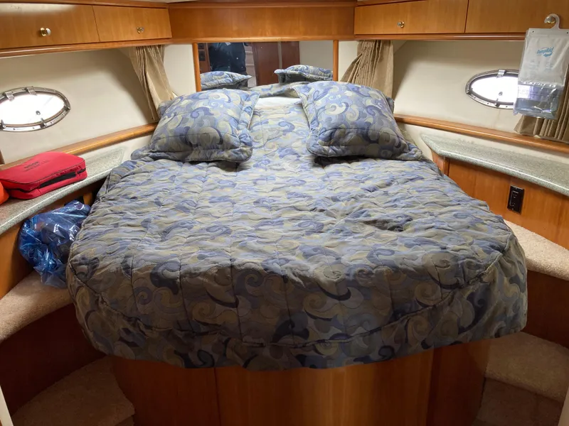 Slide: The Image of Cozy cabin bedroom in 2001 Carver 396 Aft Cabin yacht with plush bedding. - 33