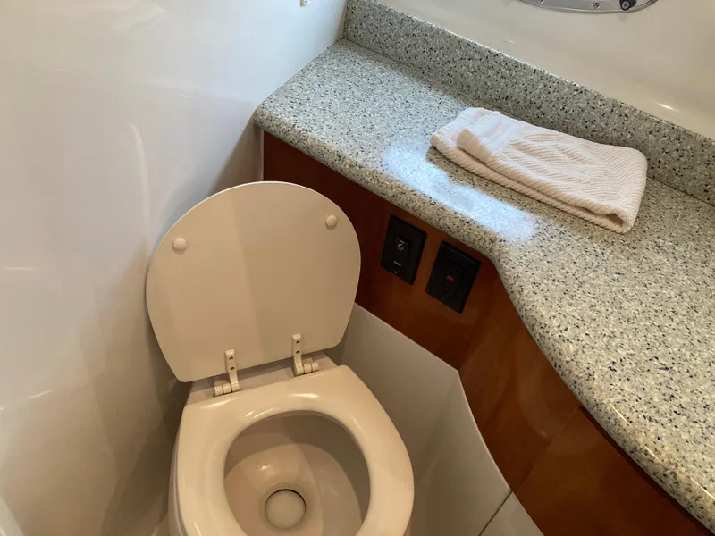 Slide: The Image of 2001 Carver 396 Aft Cabin bathroom with toilet, granite countertop, and towel. - 41