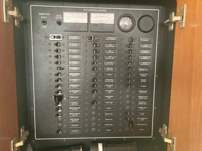 Slide: The Image of 2001 Carver 396 Aft Cabin DC control panel with switches and gauges. - 44