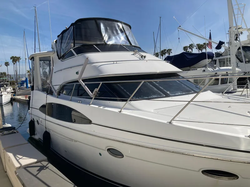 Slide: The Image of 2001 Carver 396 Aft Cabin yacht docked in a marina under clear skies. - 9