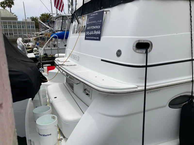 Slide: The Image of 2001 Carver 396 Aft Cabin yacht docked, featuring sleek white exterior and marina setting. - 11