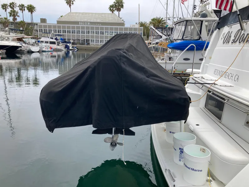 Slide: The Image of Covered boat engine on a 2001 Carver 396 Aft Cabin yacht in a marina. - 13