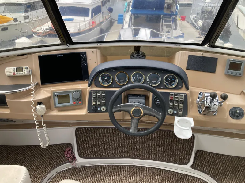 Slide: The Image of Helm of 2001 Carver 396 Aft Cabin with navigation instruments and steering wheel. - 14