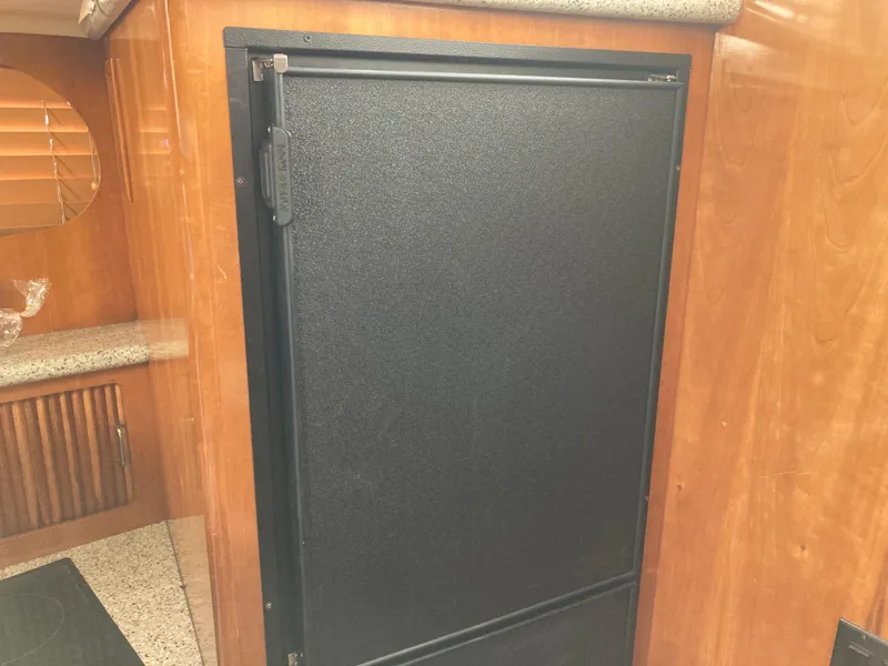 Slide: The Image of Black refrigerator in 2001 Carver 396 Aft Cabin yacht interior. - 30