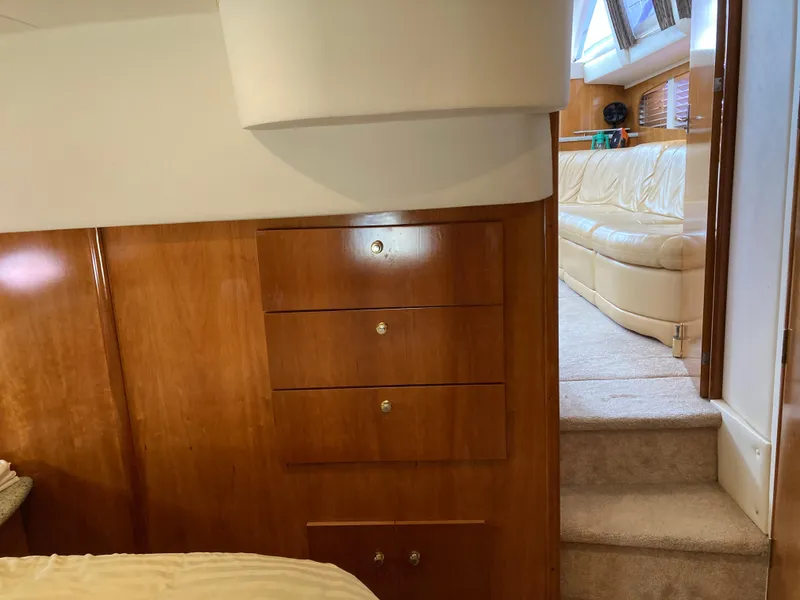 Slide: The Image of Interior of 2001 Carver 396 Aft Cabin with wooden drawers and beige seating area. - 38