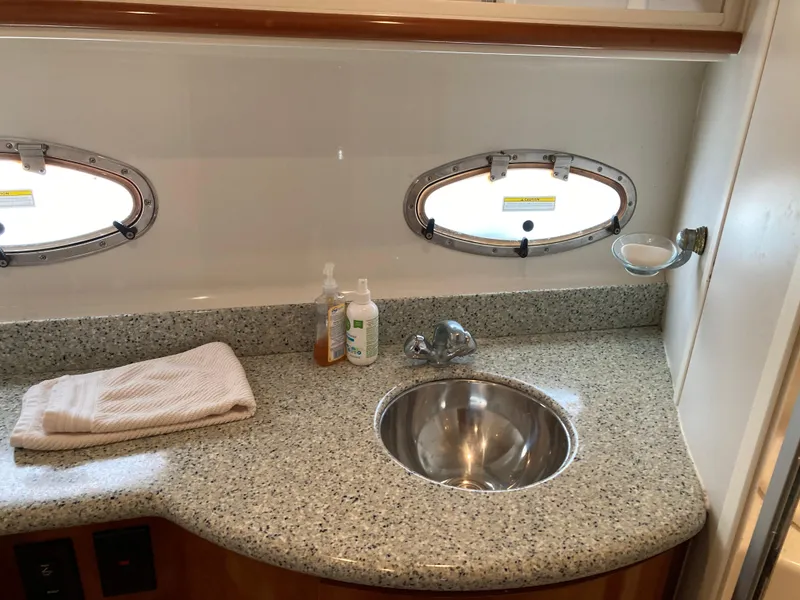 Slide: The Image of 2001 Carver 396 Aft Cabin bathroom with granite countertop and stainless steel sink. - 39