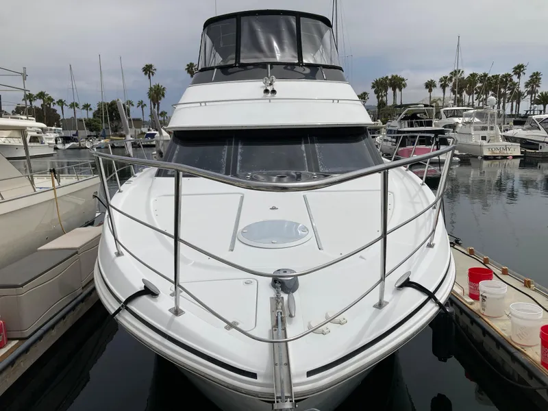 Slide: The Image of 2001 Carver 396 Aft Cabin yacht docked in marina, surrounded by other boats. - 4
