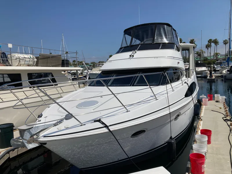 Slide: The Image of 2001 Carver 396 Aft Cabin yacht docked at marina under clear blue sky. - 7