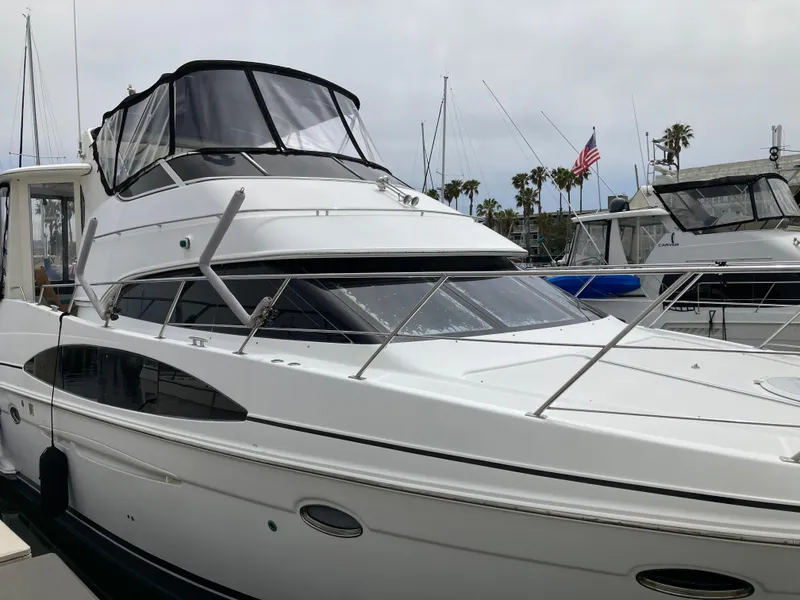 Slide: The Image of 2001 Carver 396 Aft Cabin yacht docked at marina with American flag in background. - 8