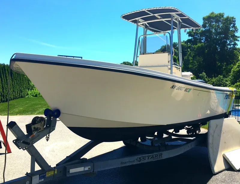 Slide: The Image of 2007 Parker 21 SE CC boat on trailer, sunny day, lush greenery background. - 5