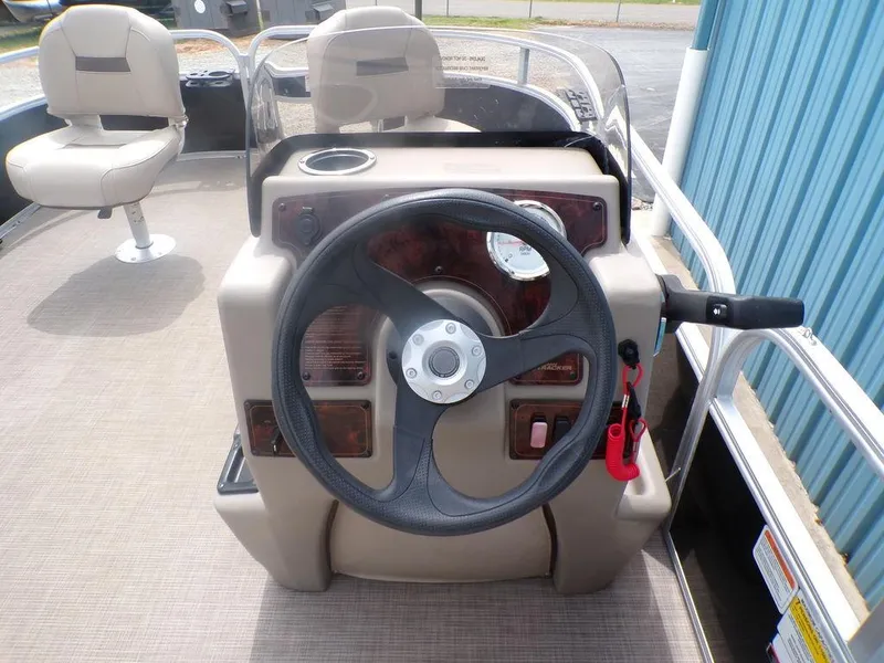 Slide: The Image of 2021 Sun Tracker BASS BUGGY® 16 DLX steering console with beige seating and controls. - 13