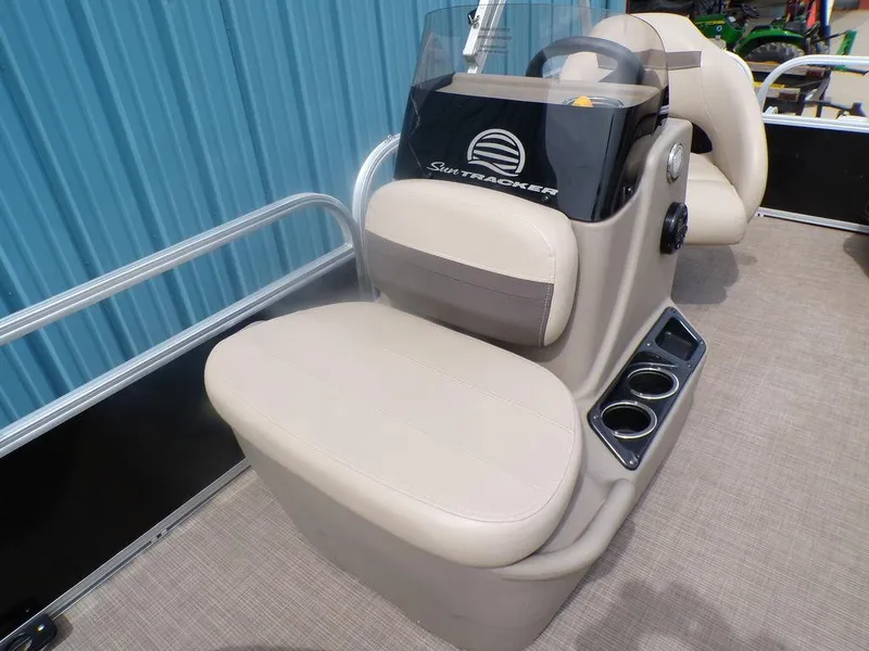 Slide: The Image of 2021 Sun Tracker BASS BUGGY® 16 DLX boat console with beige seating and cup holders. - 14