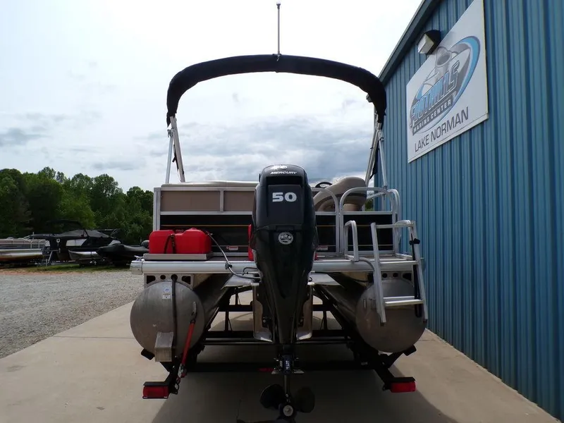 Slide: The Image of 2021 Sun Tracker BASS BUGGY® 16 DLX pontoon boat with 50 HP motor, docked at Lake Norman. - 3