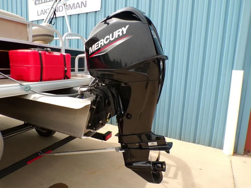 Slide: The Image of 2021 Sun Tracker BASS BUGGY® 16 DLX with Mercury outboard motor, docked near blue wall. - 7