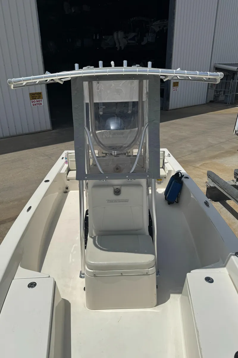 Slide: The Image of 2014 Pathfinder 2200 TRS boat with center console, docked in a marina. - 12