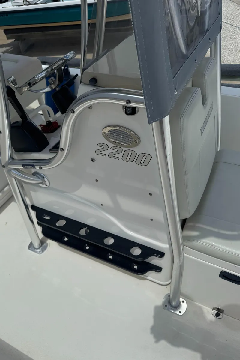 Slide: The Image of 2014 Pathfinder 2200 TRS boat interior with steering console and seating. - 13