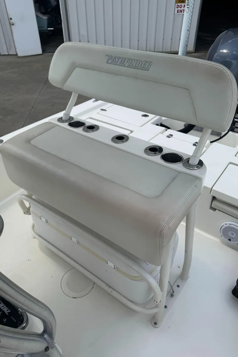 Slide: The Image of 2014 Pathfinder 2200 TRS boat seat with rod holders and storage compartment. - 15