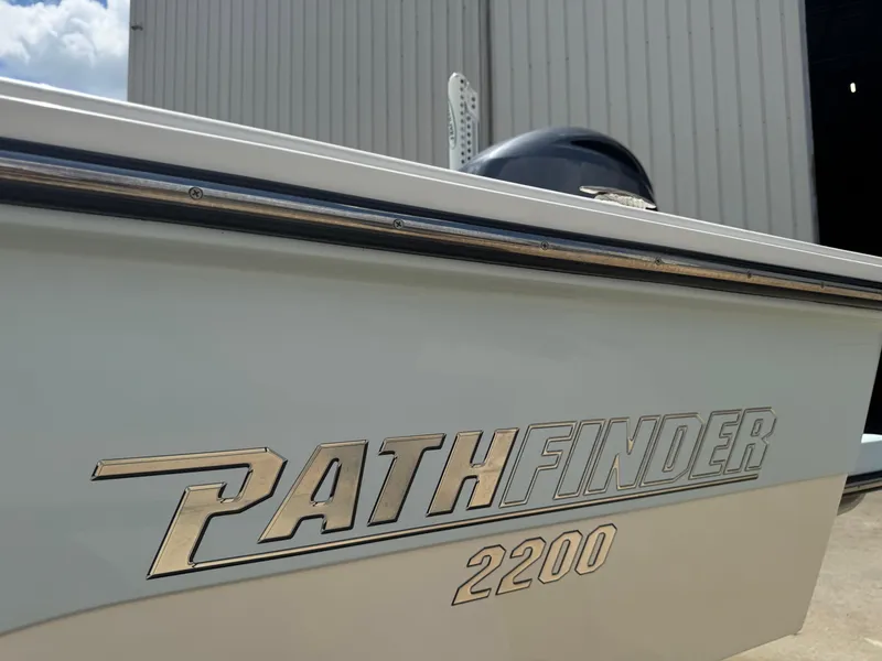 Slide: The Image of 2014 Pathfinder 2200 TRS boat side view with logo and engine detail. - 16