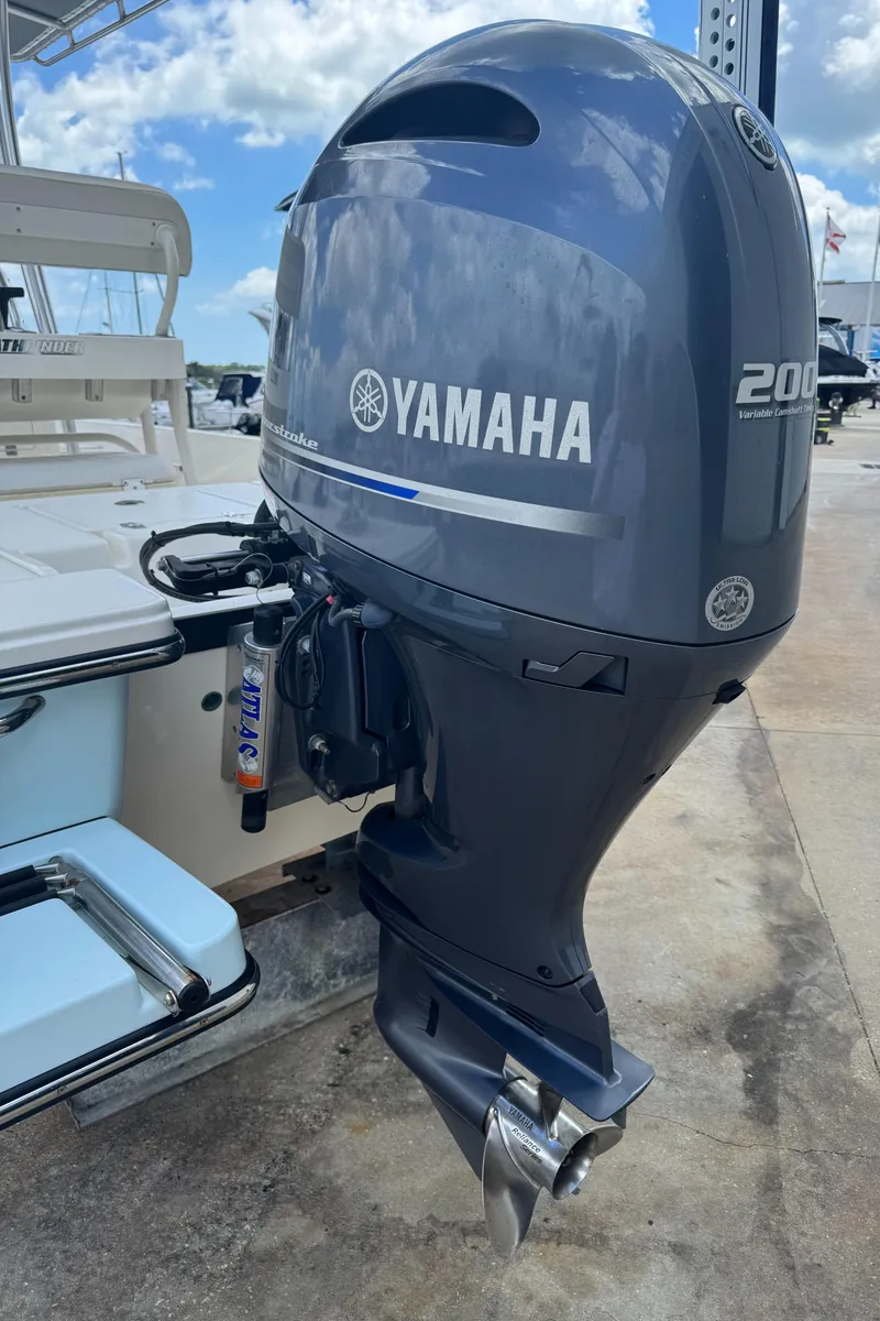 Slide: The Image of 2014 Pathfinder 2200 TRS with Yamaha 200 outboard motor, docked under blue sky. - 19