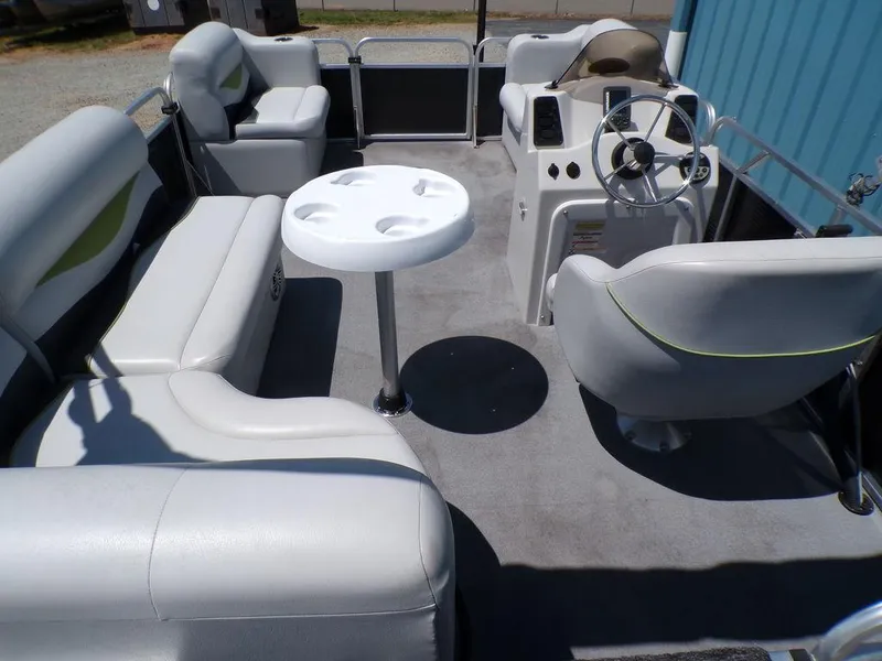 Slide: The Image of 2020 Qwest Edge 816 Cruise boat interior with white seating and steering console. - 14