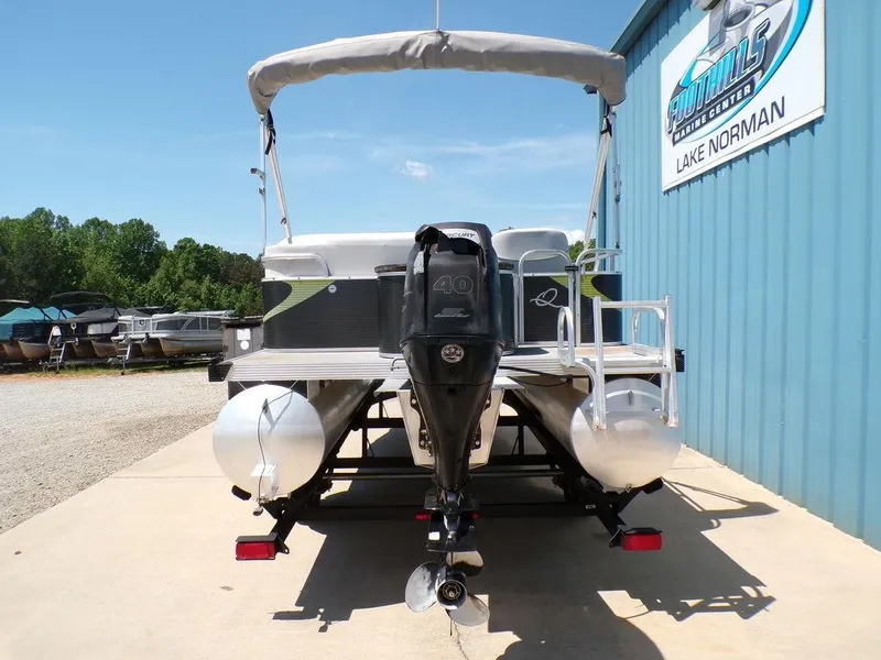Slide: The Image of 2020 Qwest Edge 816 Cruise pontoon boat with outboard motor, parked at a marina. - 6