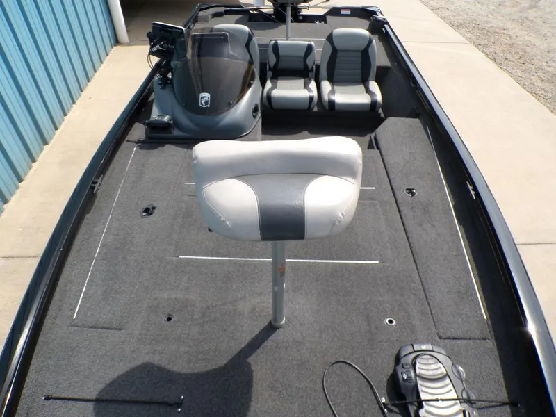 Slide: The Image of 2014 Lowe Stinger ST195 boat interior with seating and steering console. - 13