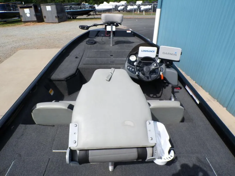 Slide: The Image of 2014 Lowe Stinger ST195 boat interior with steering wheel and navigation equipment. - 17