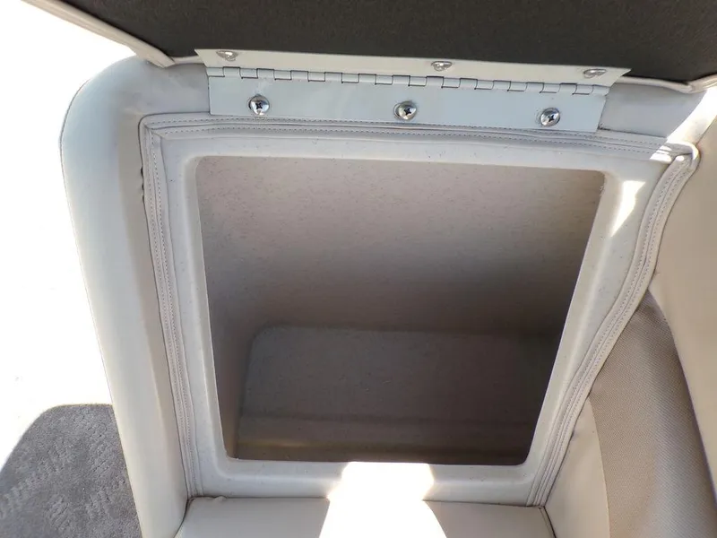 Slide: The Image of Open storage compartment in a 2013 JC Limited 221 Triple boat. - 12
