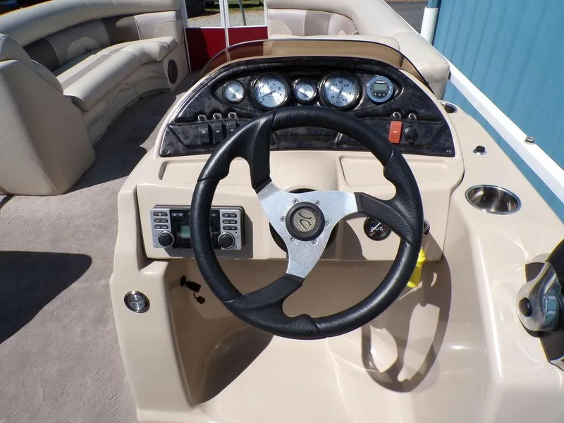 Slide: The Image of Steering console of a 2013 JC Limited 221 Triple pontoon boat with gauges and controls. - 16