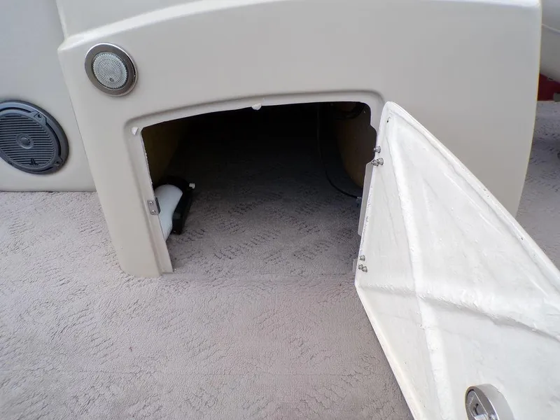 Slide: The Image of Open storage compartment on a 2013 JC Limited 221 Triple boat. - 17