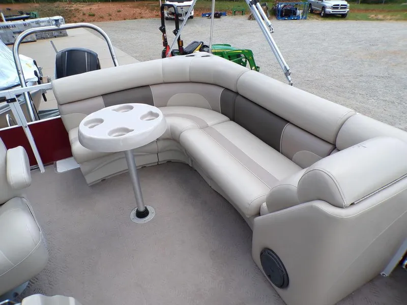 Slide: The Image of 2013 JC Limited 221 Triple pontoon boat interior with beige seating and round table. - 20