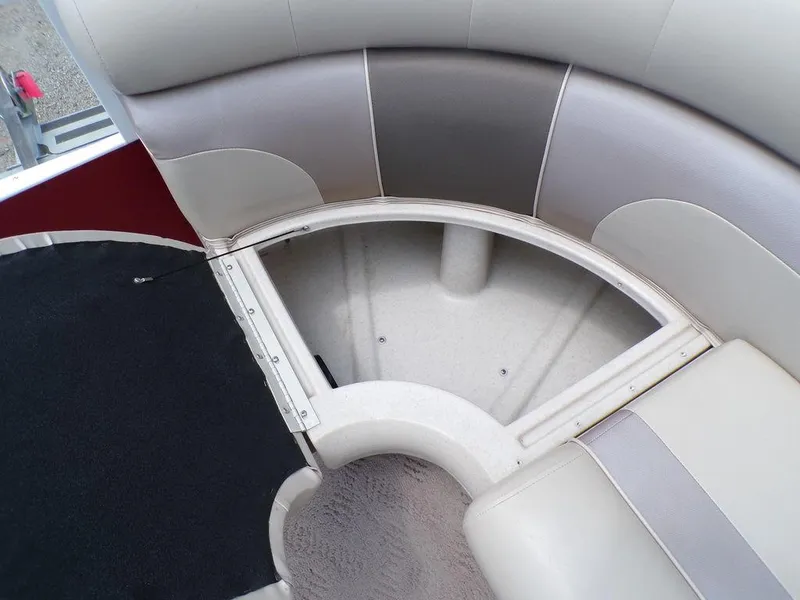 Slide: The Image of 2013 JC Limited 221 Triple boat seating with storage compartment, featuring beige and gray upholstery. - 22