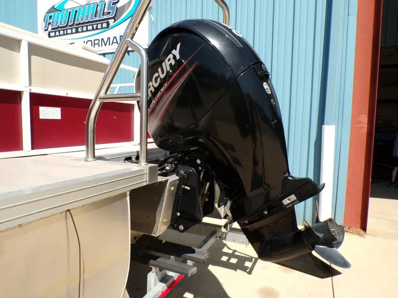 Slide: The Image of Outboard motor on a 2013 JC Limited 221 Triple boat at a marine center. - 6